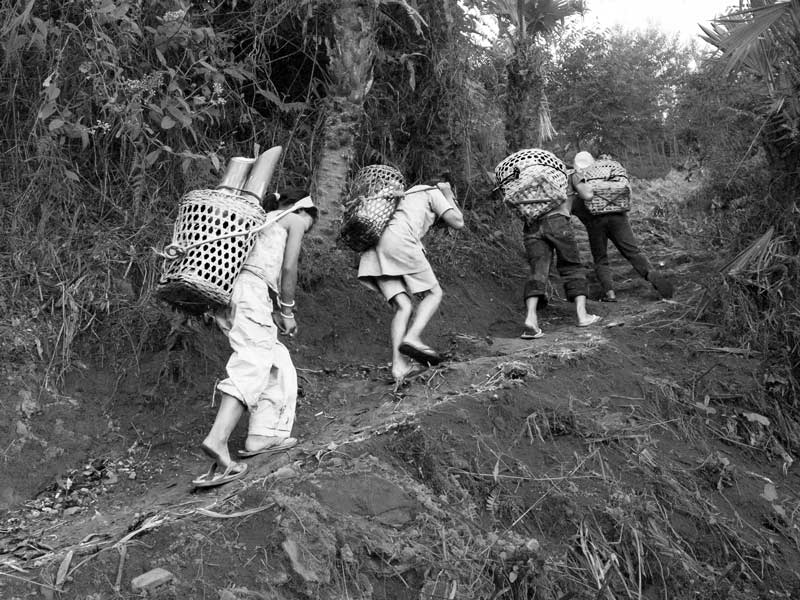 Human Right to Water in Nagaland - Children carrying heavy water loads up a hilly track in Tuensang district